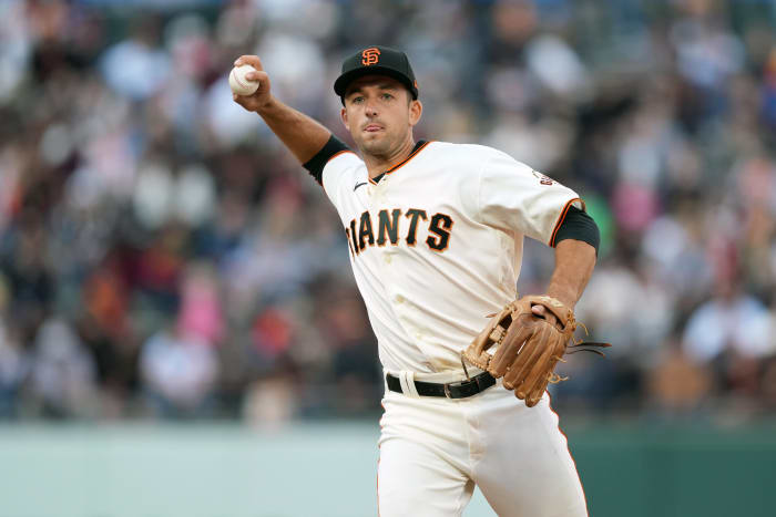 SF Giants infielder Jason Vosler throws a ball to first base.